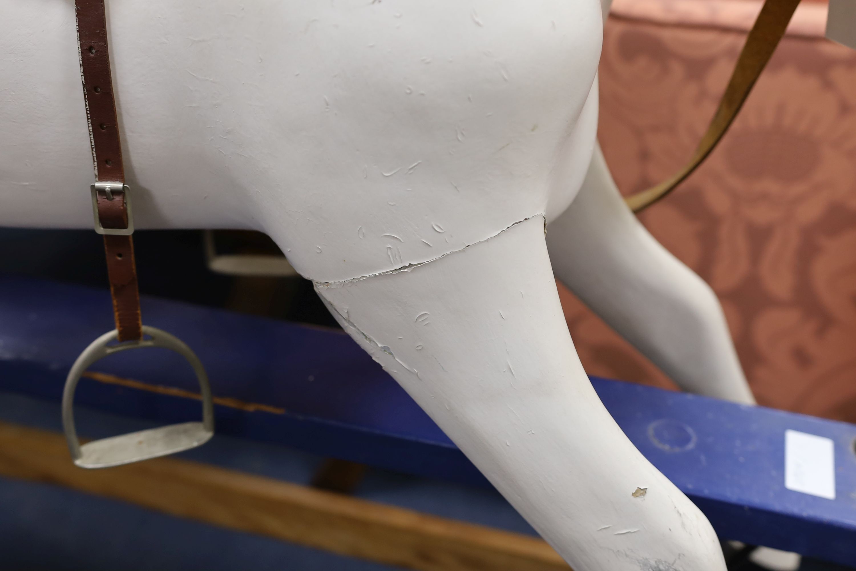An early 20th century rocking horse on painted safety frame, (re-painted) width 126cm, height 114cm